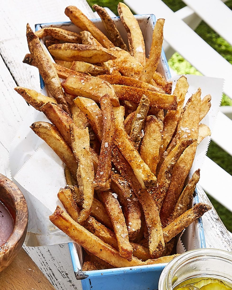 old bay french fries served in a parchment lined light blue loaf pan