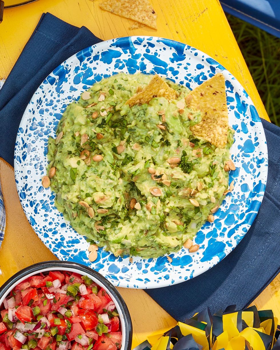 pepita guacamole in a blue and white speckled bowl
